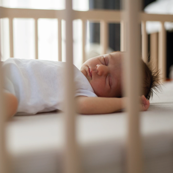 Bebe pequeño durmiendo en cuna